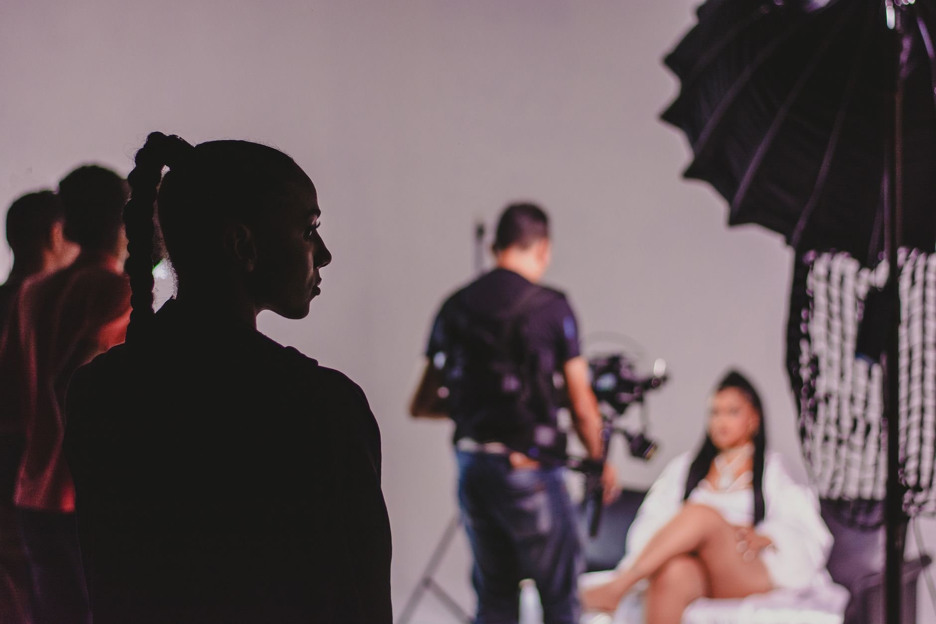 Capturing the essence of a fashion photo shoot with models and photographers in a studio.